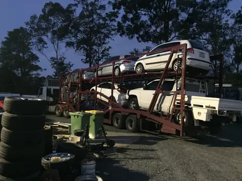 Auto Mover Car Carrier Loaded with Multiple White Vehicles