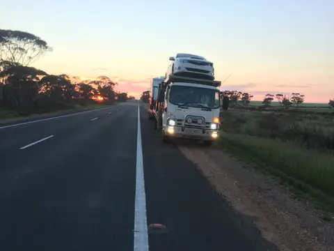 Auto Mover Car Carrier Transporting Vehicles at Dusk