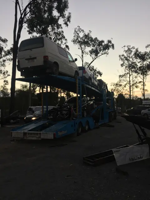 Auto Mover Double Deck Carrier Loading Vehicles at Dusk