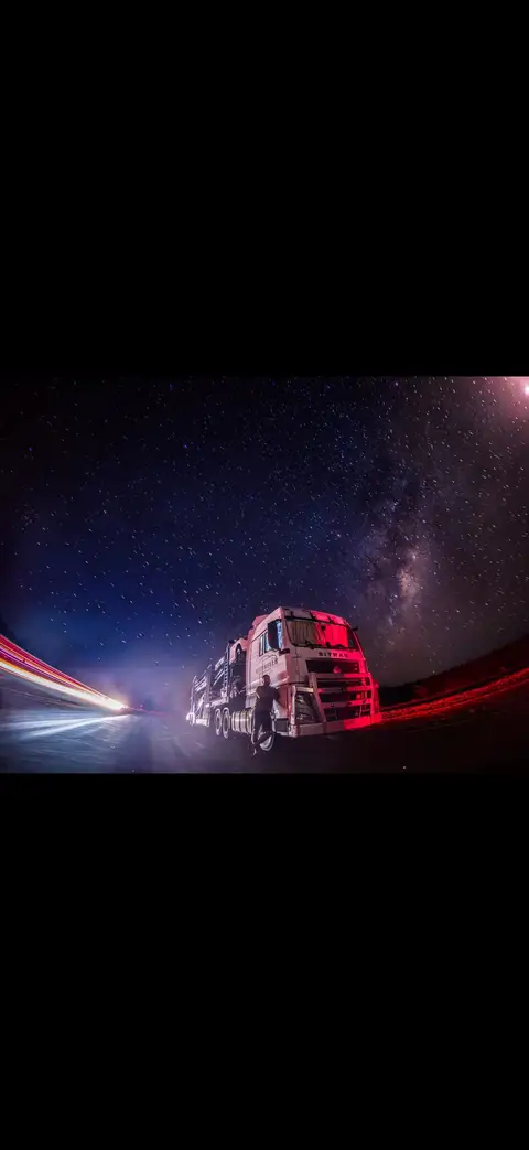 Auto Mover Truck on Highway Under Starry Night Sky
