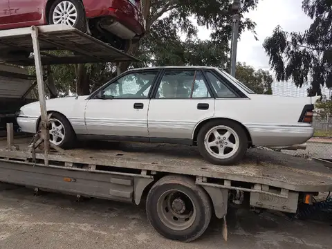 Auto Mover White Holden Sedan on Transport Truck